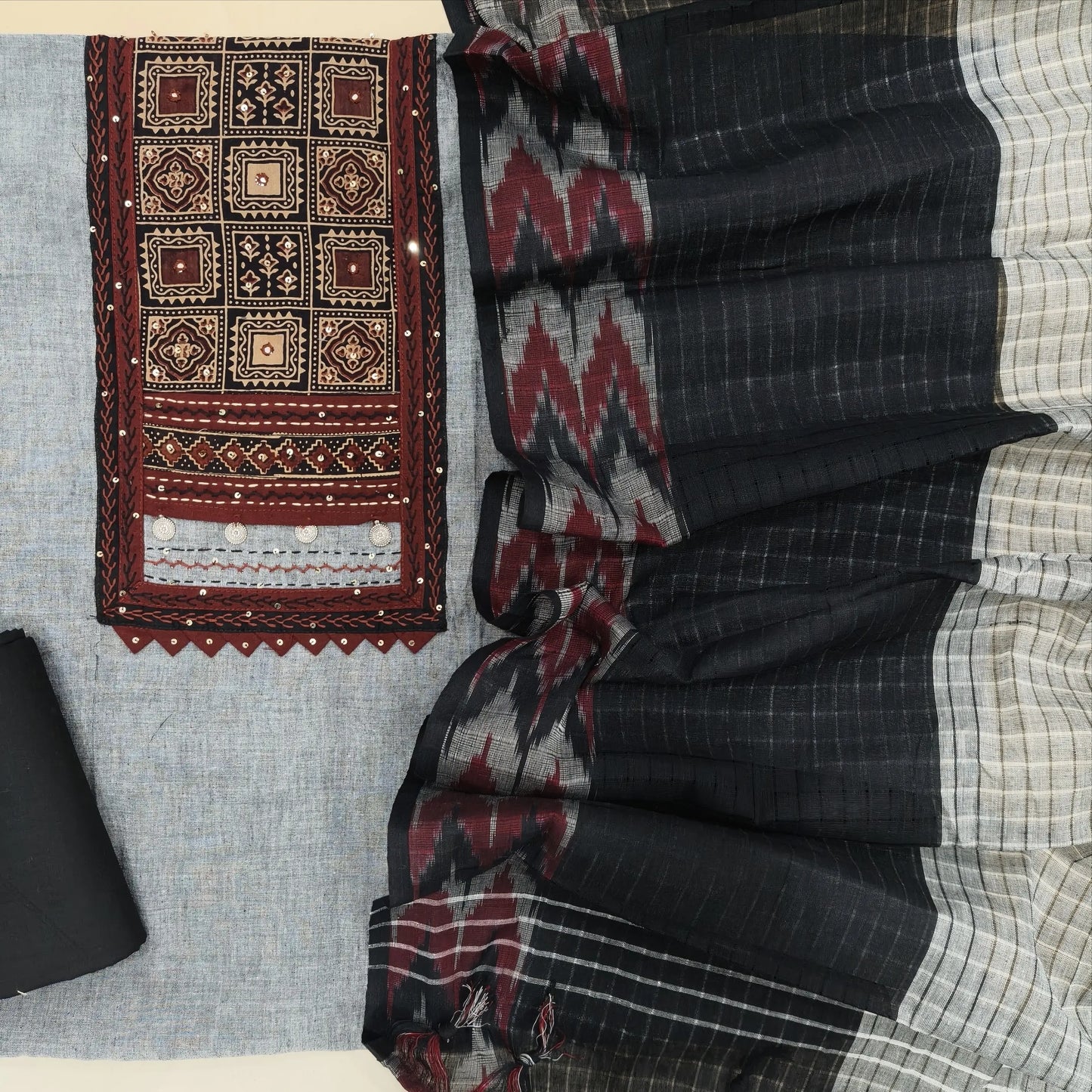 Light grey south handloom cotton unstitched salwar material, ajrak block printed yoke with thread& sequins work(lining needed)black cotton bottom, south handloom cotton dupatta with ikat woven borders. AG260815