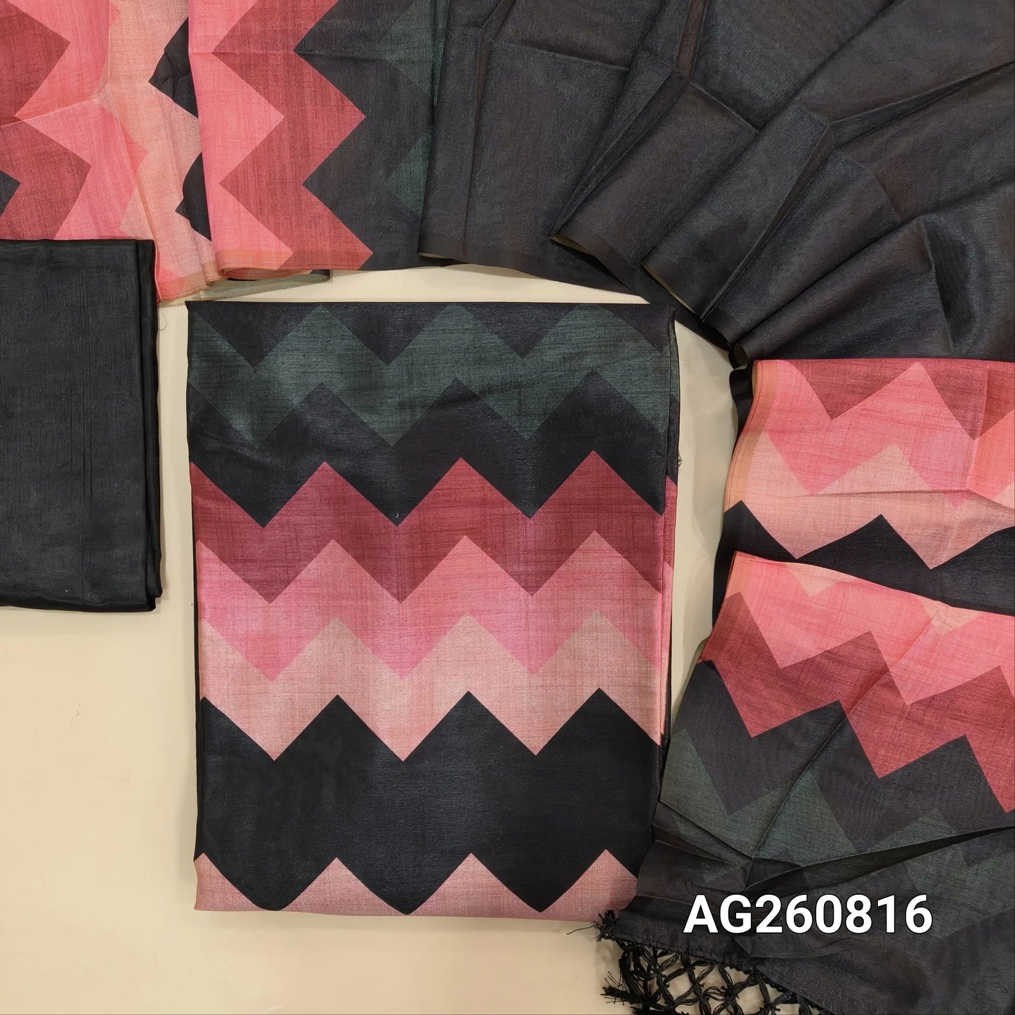 Black semi tussar unstitched salwar material (shiny, lining needed) digital colorful zigzag print on yoke, matching silky bottom, Digital printed semi tussar full length dupatta with tassels. AG260816