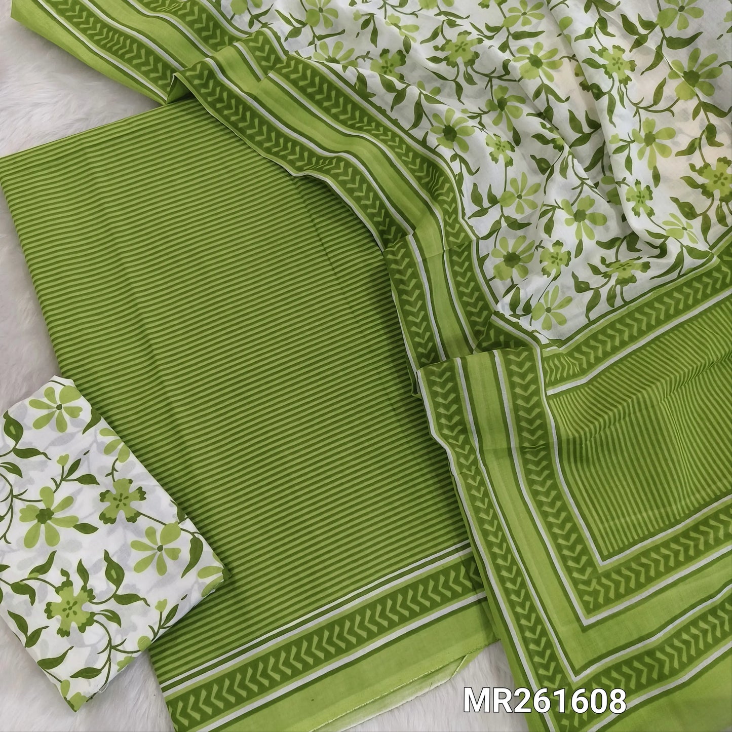 Green cambric cotton unstitched salwar material,vertical stripes all over,(lining optional)floral printed cambric cotton bottom, floral printed full length cambric cotton dupatta with pallu and printed borders. MR261608