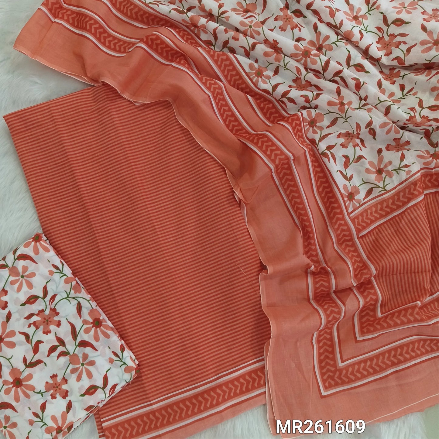 Peach cambric cotton unstitched salwar material,vertical stripes all over,(lining optional)floral printed cambric cotton bottom, floral printed full length cambric cotton dupatta with pallu and printed borders. MR261609