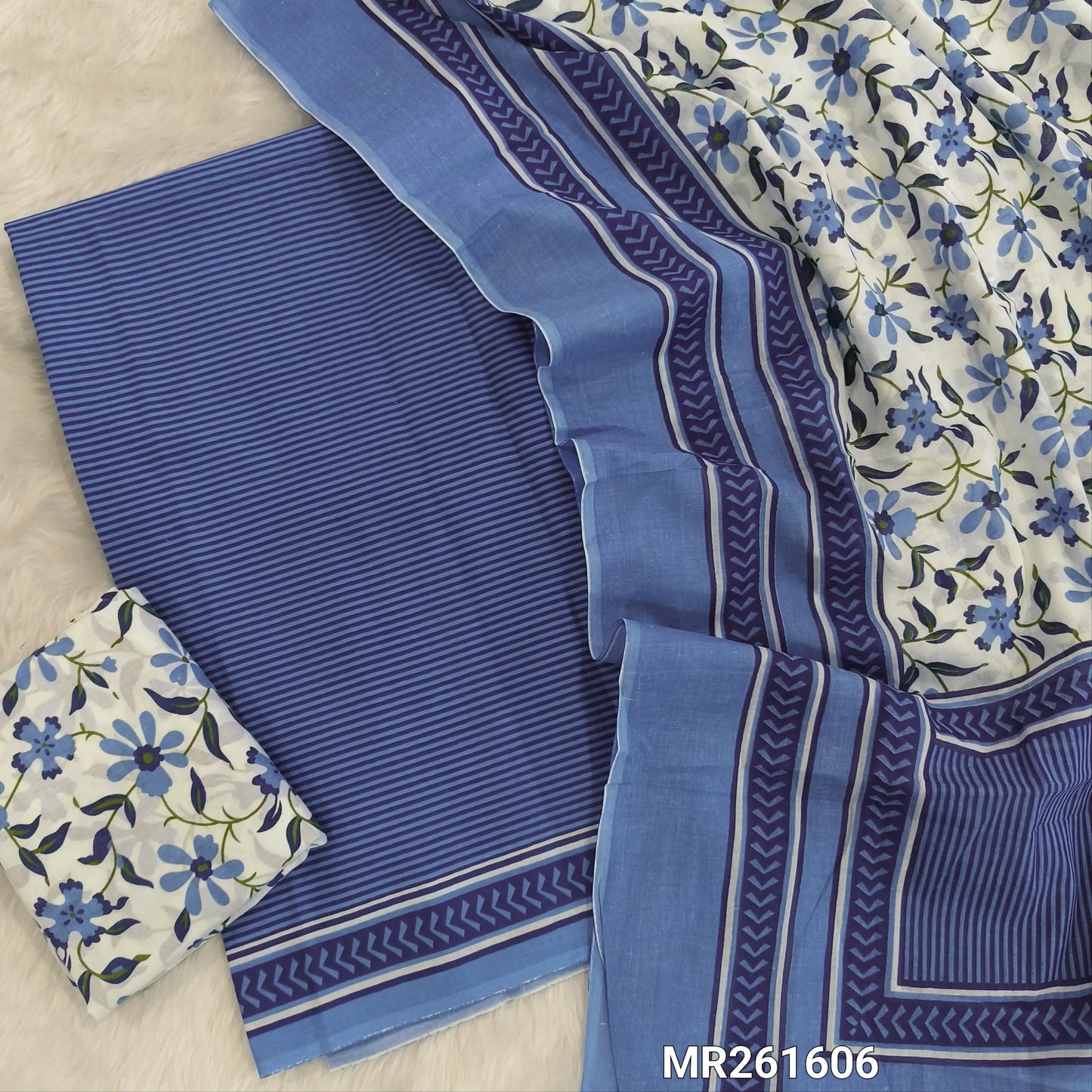 Blue cambric cotton unstitched salwar material,vertical stripes all over,(lining optional)floral printed cambric cotton bottom, floral printed full length cambric cotton dupatta with pallu and printed borders. MR261606