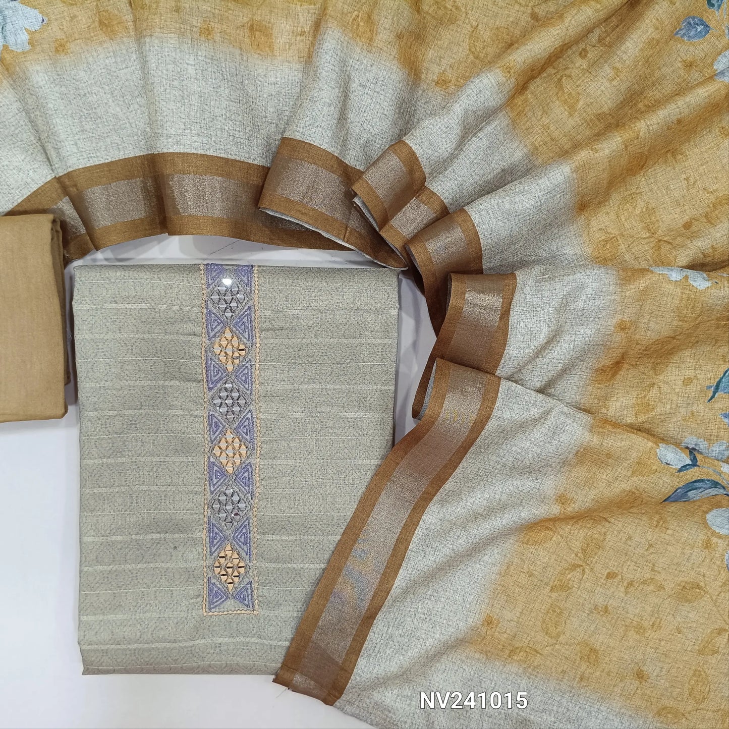 Beige sobar printed semi gicha unstitched salwar material, embroidered& real mirror work on yoke, self weaving design all over(lining needed)yellowish beige santoon bottom, floral printed semi gicha dupatta with gold tissue borders. CODE NV241015