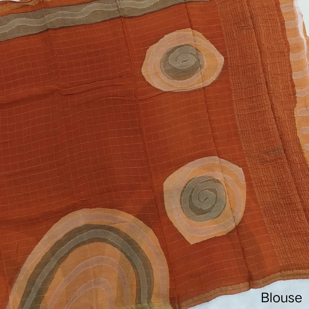 Rust Orange Viscous Chanderi silk saree with shibori prints all over and zari checks all over, thin zari woven borders and running viscous chanderi zari woven blouse. NS58