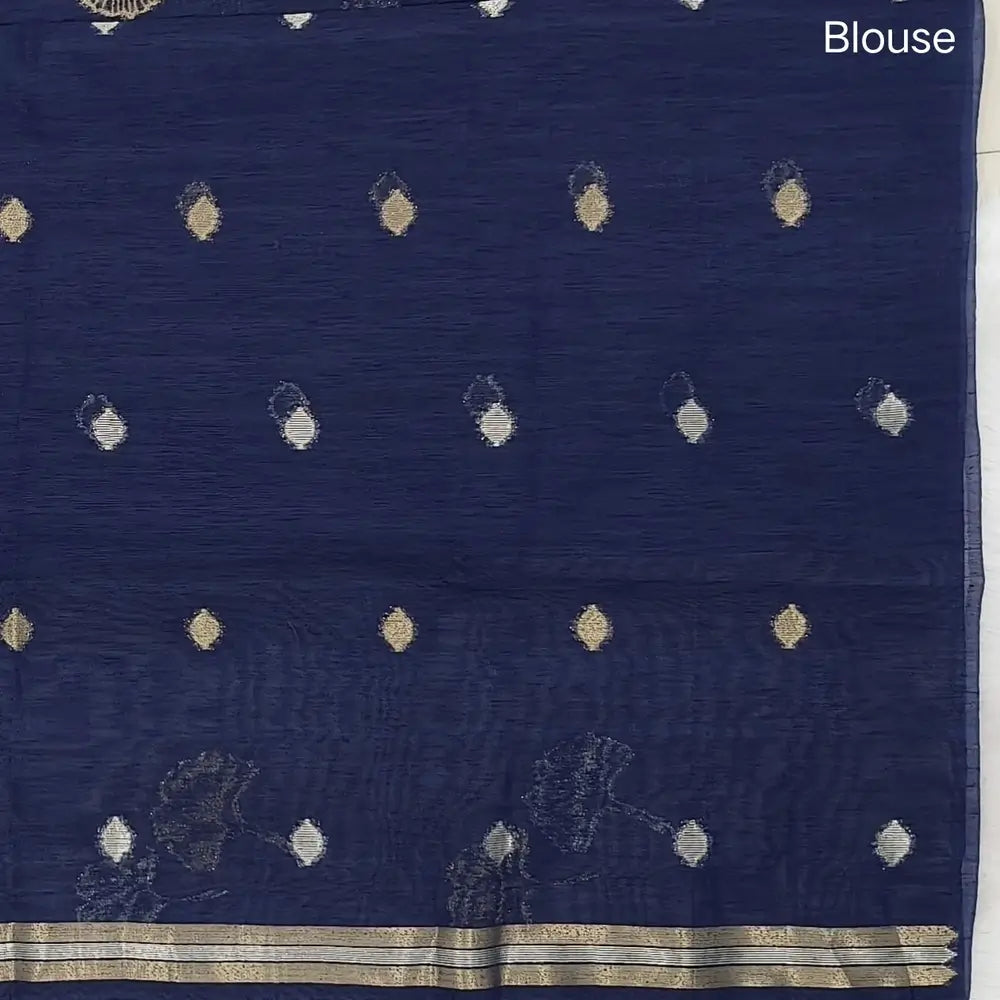 Dark blue premium tussar jamdani saree with gold and silver zari weaving all over, rich weaving on pallu, running blouse with zari woven buttas and borders. NS78