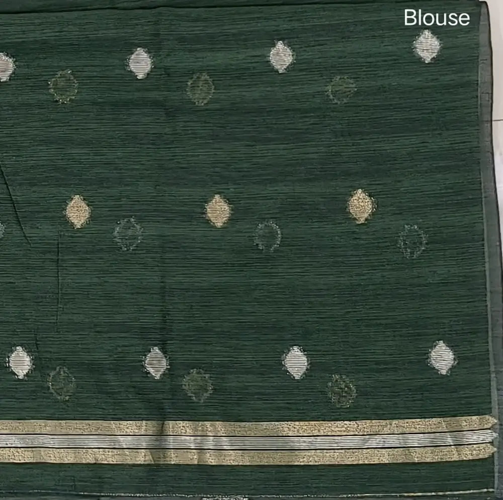 Bottle green premium tussar jamdani saree with gold and silver zari weaving all over, rich weaving on pallu, running blouse with zari woven buttas and borders. NS75