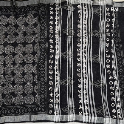 Black block printed linen cotton saree with double side silver zari borders (lightweight,soft) printed pallu with silver zari stripes, plain running blouse with borders. NS111
