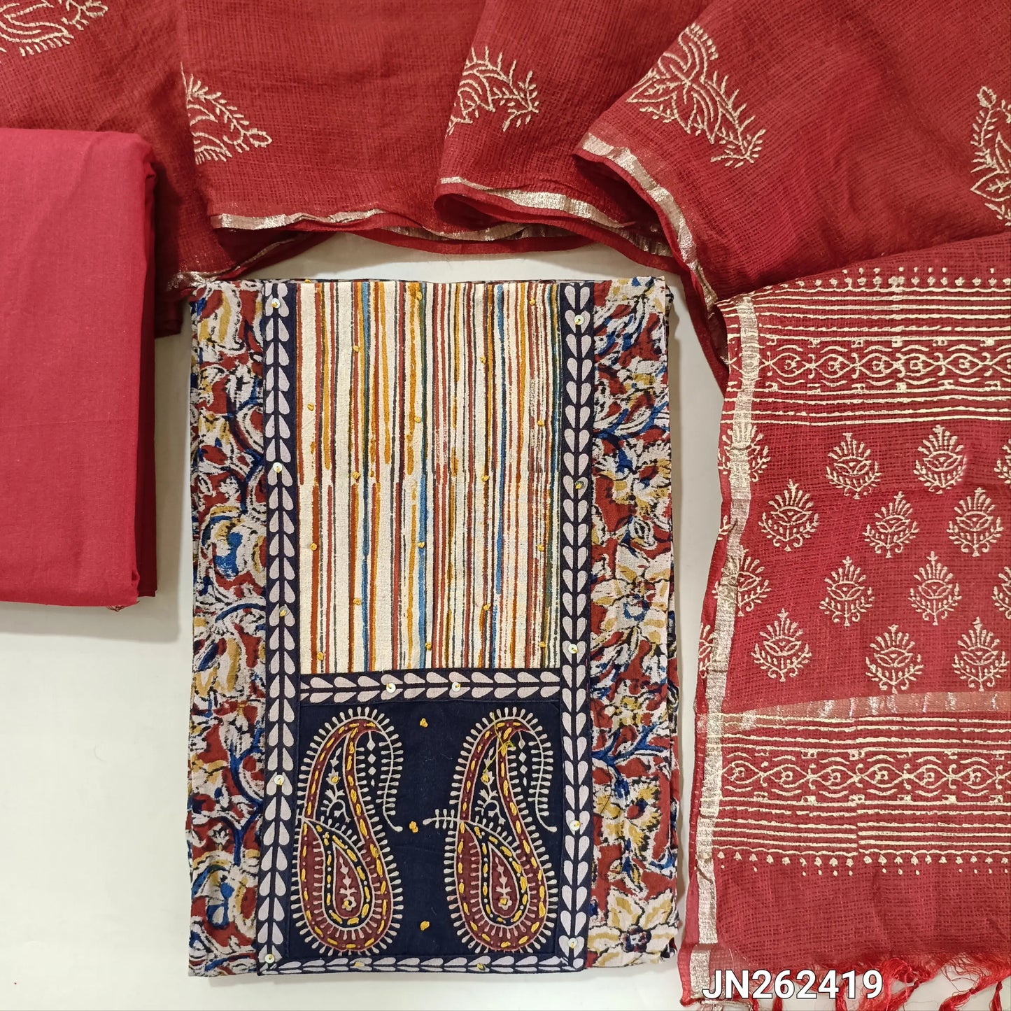 Reddish maroon kalamkari hand block printed pure cotton unstitched salwar material,ajrak patch with hand embroidery ( Lining optional )matching cotton bottom,hand block printed kota silk cotton dupatta with gold tissue borders.JN262419