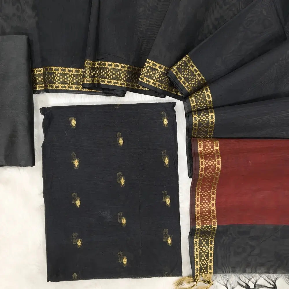 Black fancy silk cotton unstitched salwar material(lining needed) zari buttas allover, matching silk cotton bottom, dual shaded fancy silk cotton dupatta with zari woven  borders & tassels. NV250805