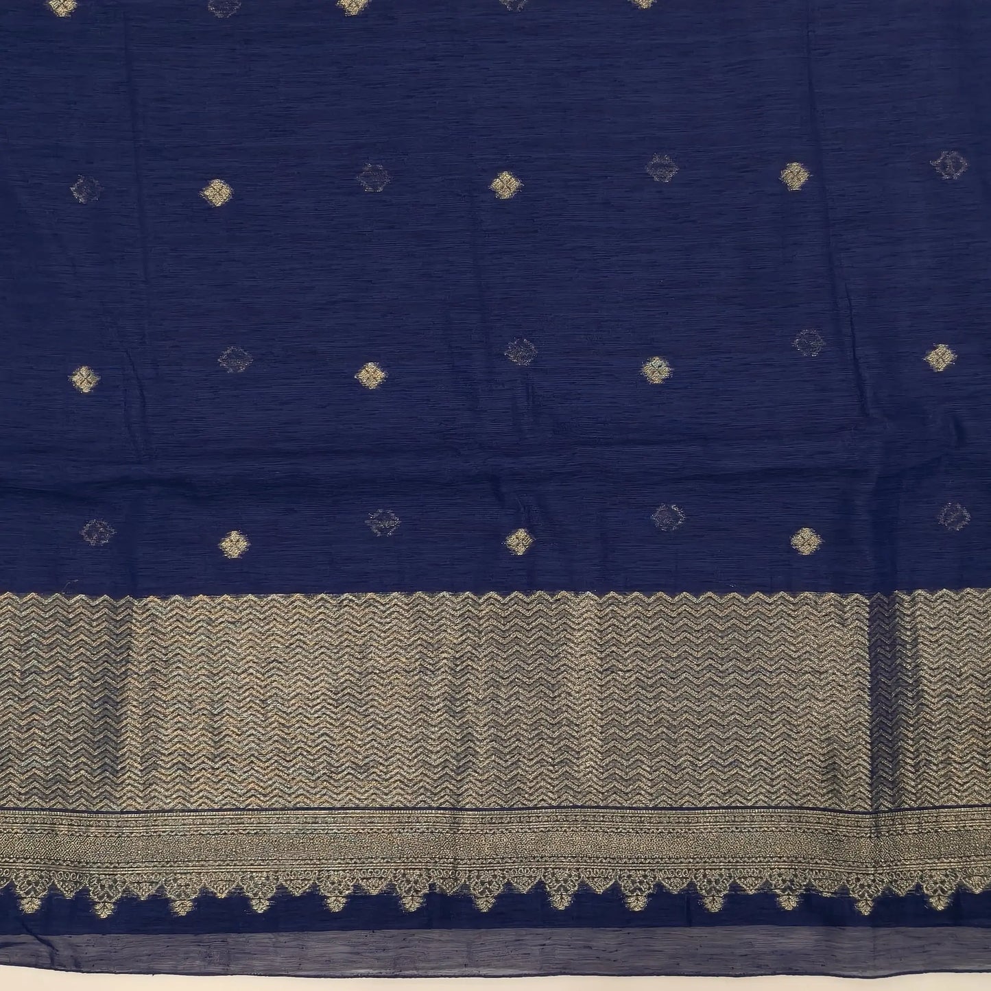 Dark blue jamdani woven premium tussar unstitched salwar material,buttas on front,antic gold zari weaving daman, (Thin, textured, lining needed)silk cotton bottom, buttas on full length tussar dupatta with rich pallu and tassles. JL261710