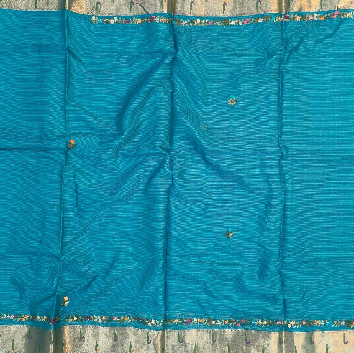 Turquoise blue premium kota silk saree(soft, thin)with rich hand embroidery work all over,paithani woven double side borders,rich zari woven pallu,with hand embroidery & sequins work,running blouse with embroidery and borders. NS255