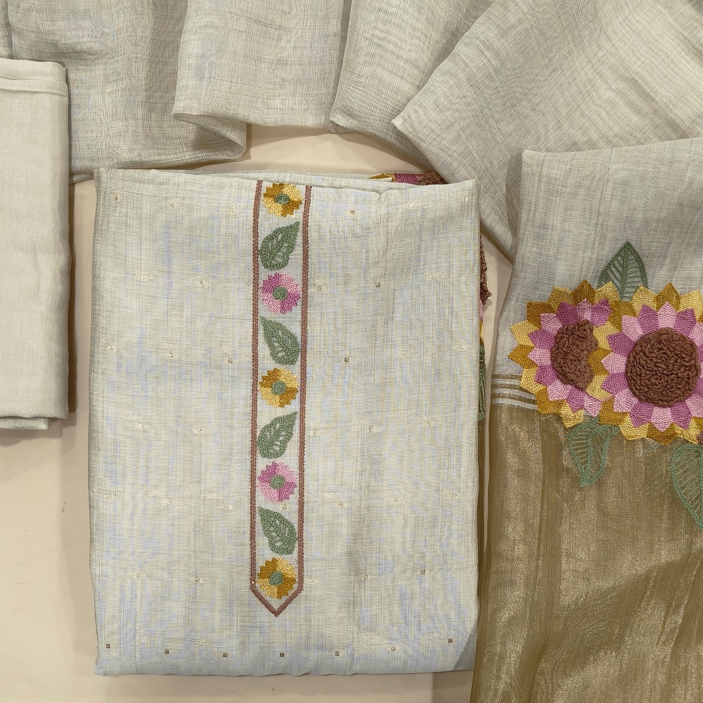 Light beige premium silk cotton unstitched salwar material,embroidery yoke,zari buttas all over,gold tissue and embroidery work on daman,(lining needed)spun cotton bottom, silk cotton dupatta with embriodery work with tissue pallu.JL261901