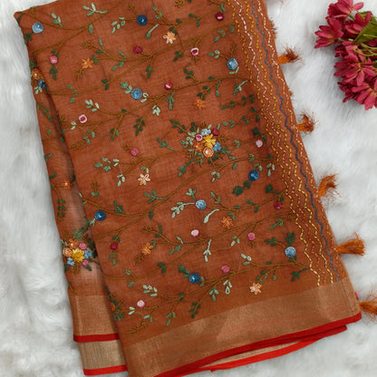 Rust orange with golden tint premium dual shaded tissue linen saree, with rich hand embroidery work all over(texture)double side tissue borders,contrast pallu, with rich hand embroidery and sequins work, running blouse with embroidery & borders. NS266