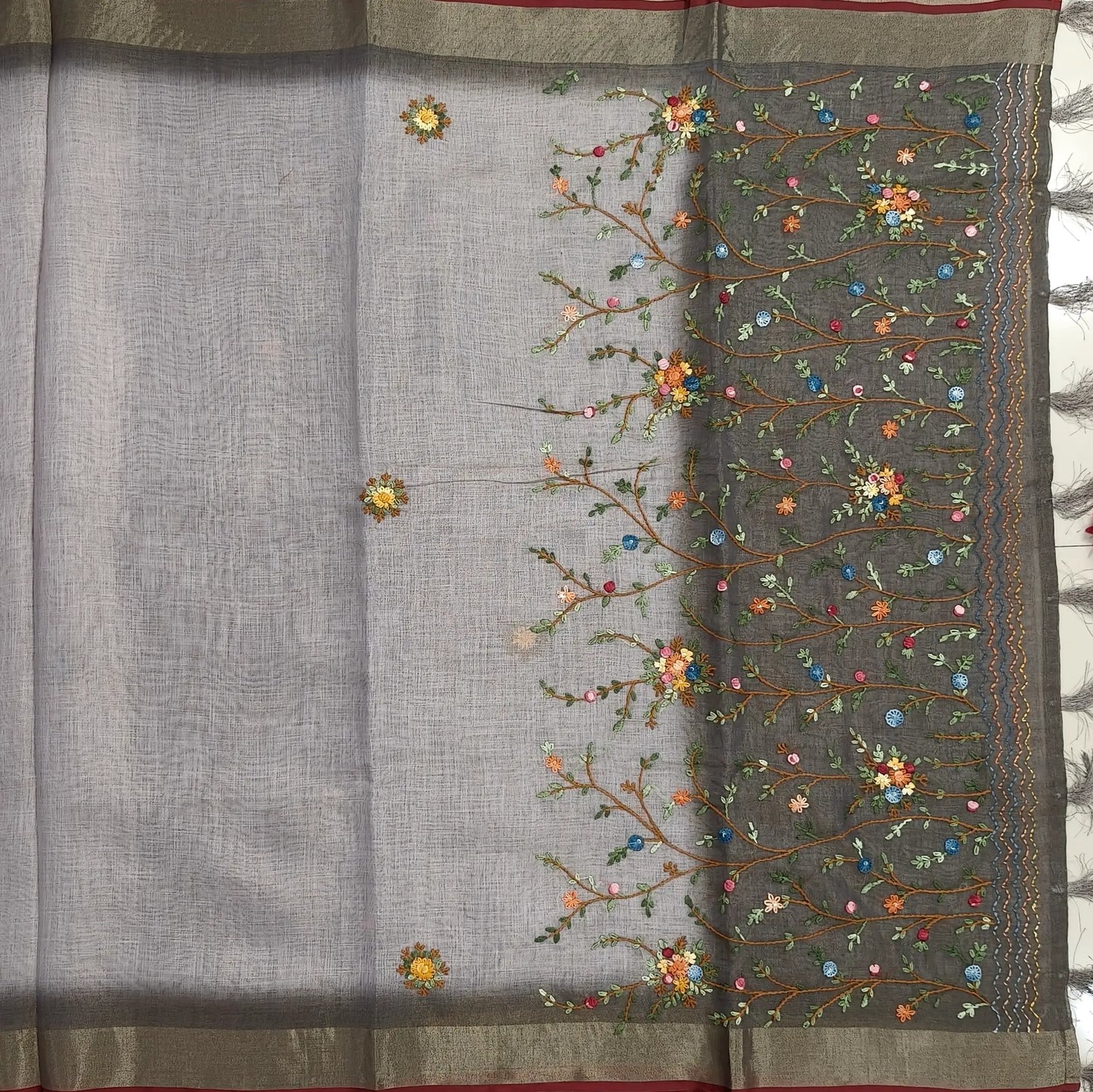 Grey with golden tint premium dual shaded tissue linen saree, with rich hand embroidery detailing all over(textured)double side tissue borders,contrast pallu, with rich hand embroidery and sequins work, running blouse with embroidery & borders. NS267