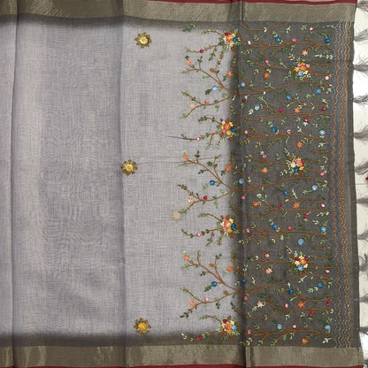Grey with golden tint premium dual shaded tissue linen saree, with rich hand embroidery detailing all over(textured)double side tissue borders,contrast pallu, with rich hand embroidery and sequins work, running blouse with embroidery & borders. NS267