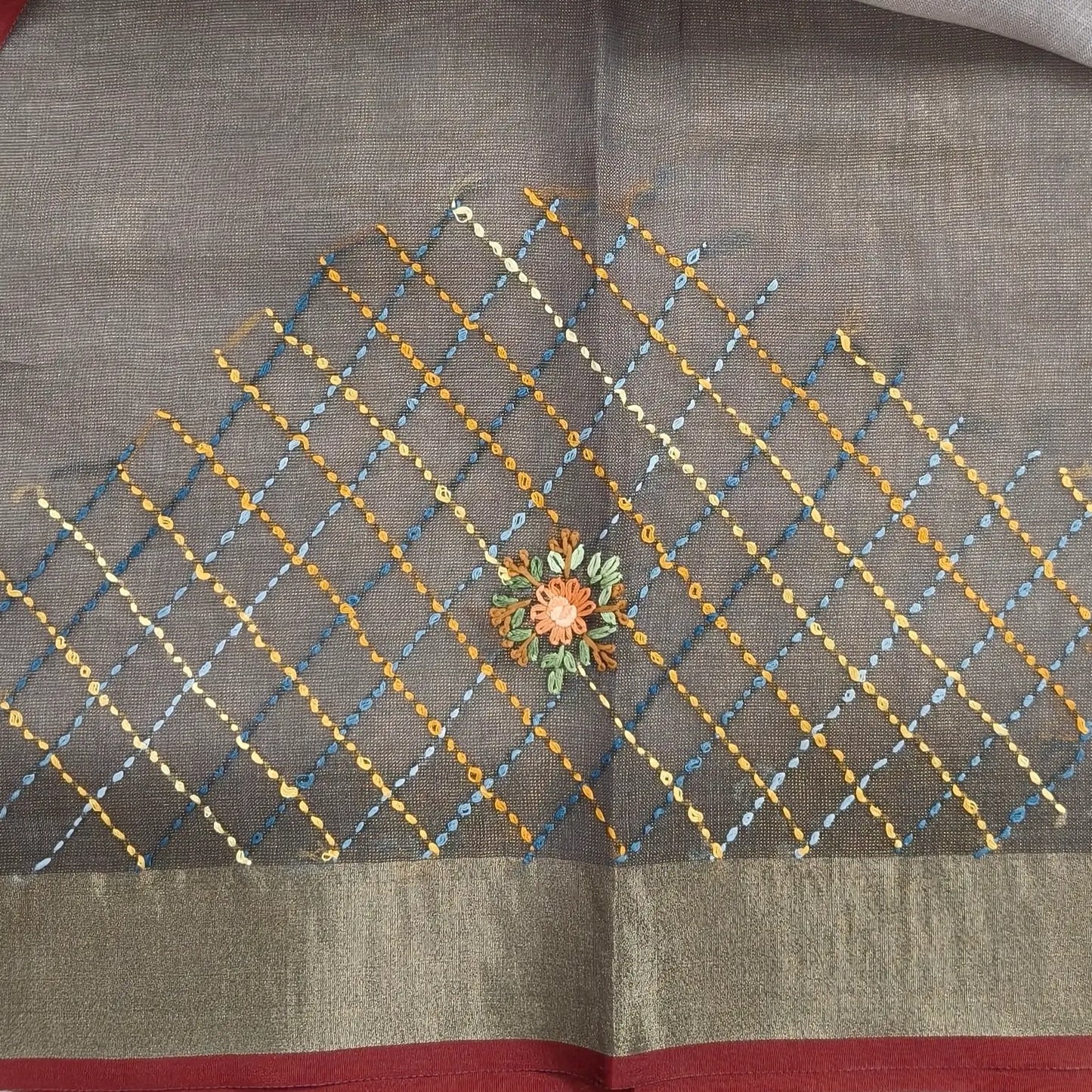 Grey with golden tint premium dual shaded tissue linen saree, with rich hand embroidery detailing all over(textured)double side tissue borders,contrast pallu, with rich hand embroidery and sequins work, running blouse with embroidery & borders. NS267
