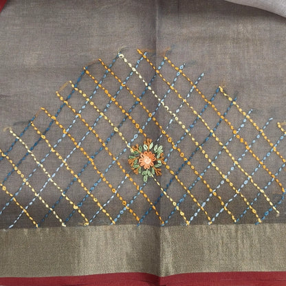 Grey with golden tint premium dual shaded tissue linen saree, with rich hand embroidery detailing all over(textured)double side tissue borders,contrast pallu, with rich hand embroidery and sequins work, running blouse with embroidery & borders. NS267