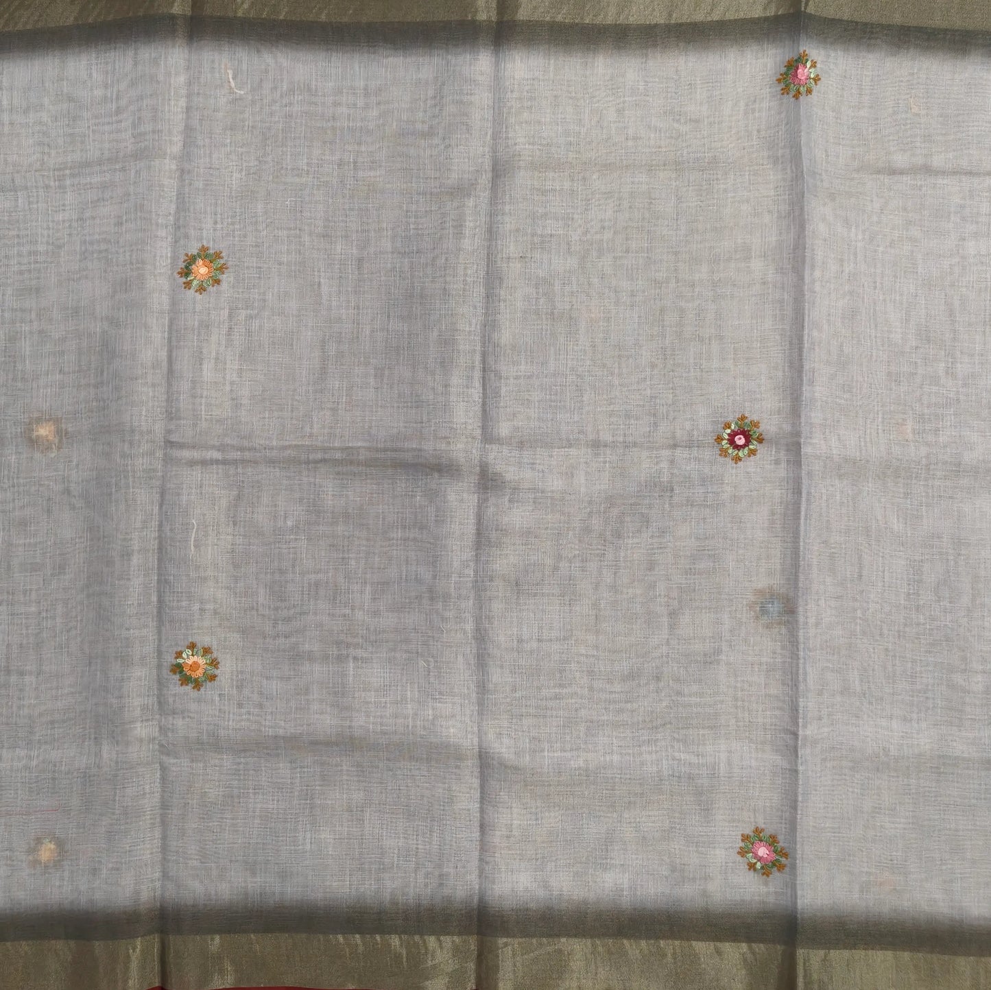 Grey with golden tint premium dual shaded tissue linen saree, with rich hand embroidery detailing all over(textured)double side tissue borders,contrast pallu, with rich hand embroidery and sequins work, running blouse with embroidery & borders. NS267