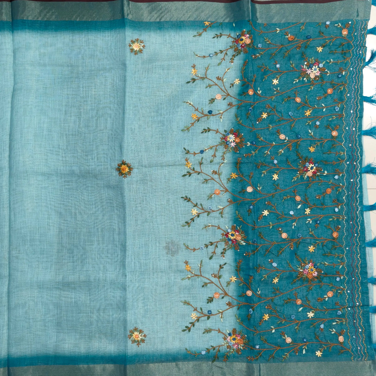 Teal blue with golden tint premium dual shaded tissue linen saree, with rich hand embroidery work all over(texture)double side tissue borders,contrast pallu, with rich hand embroidery and sequins work, running blouse with embroidery & borders. NS264