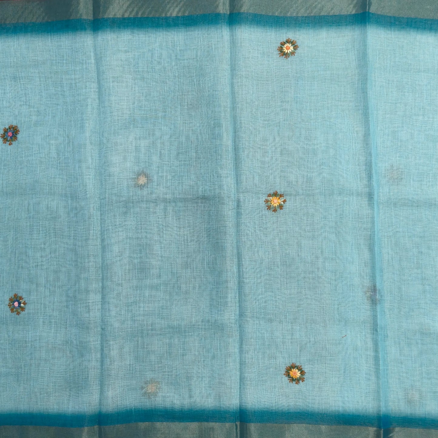 Teal blue with golden tint premium dual shaded tissue linen saree, with rich hand embroidery work all over(texture)double side tissue borders,contrast pallu, with rich hand embroidery and sequins work, running blouse with embroidery & borders. NS264