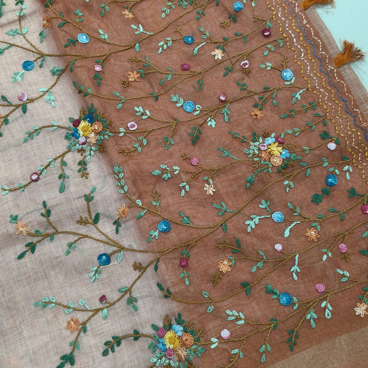 Rust orange with golden tint premium dual shaded tissue linen saree, with rich hand embroidery work all over(texture)double side tissue borders,contrast pallu, with rich hand embroidery and sequins work, running blouse with embroidery & borders. NS266