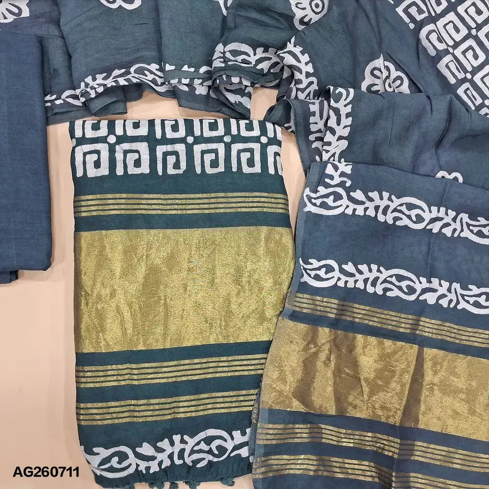 Blueish grey original batik dyed fancy silk cotton unstitched salwar material(lining needed) tissue borders on daman, matching silky bottom, batik dyed fancy silk cotton dupatta with tissue border on pallu, pompom tapings. AG260711