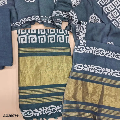 Blueish grey original batik dyed fancy silk cotton unstitched salwar material(lining needed) tissue borders on daman, matching silky bottom, batik dyed fancy silk cotton dupatta with tissue border on pallu, pompom tapings. AG260711