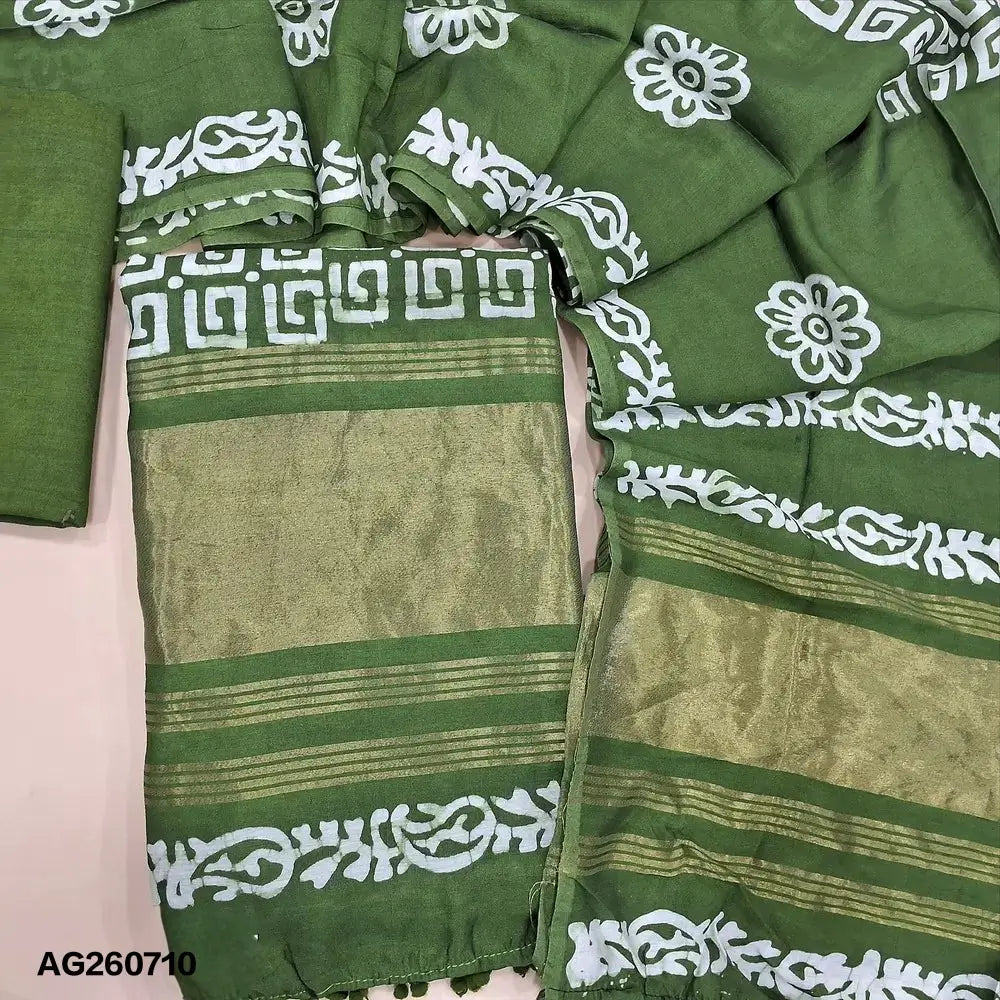 Green original batik dyed fancy silk cotton unstitched salwar material(lining needed) tissue borders on daman, matching silky bottom, batik dyed fancy silk cotton dupatta with tissue border on pallu, pompom tapings. AG260710