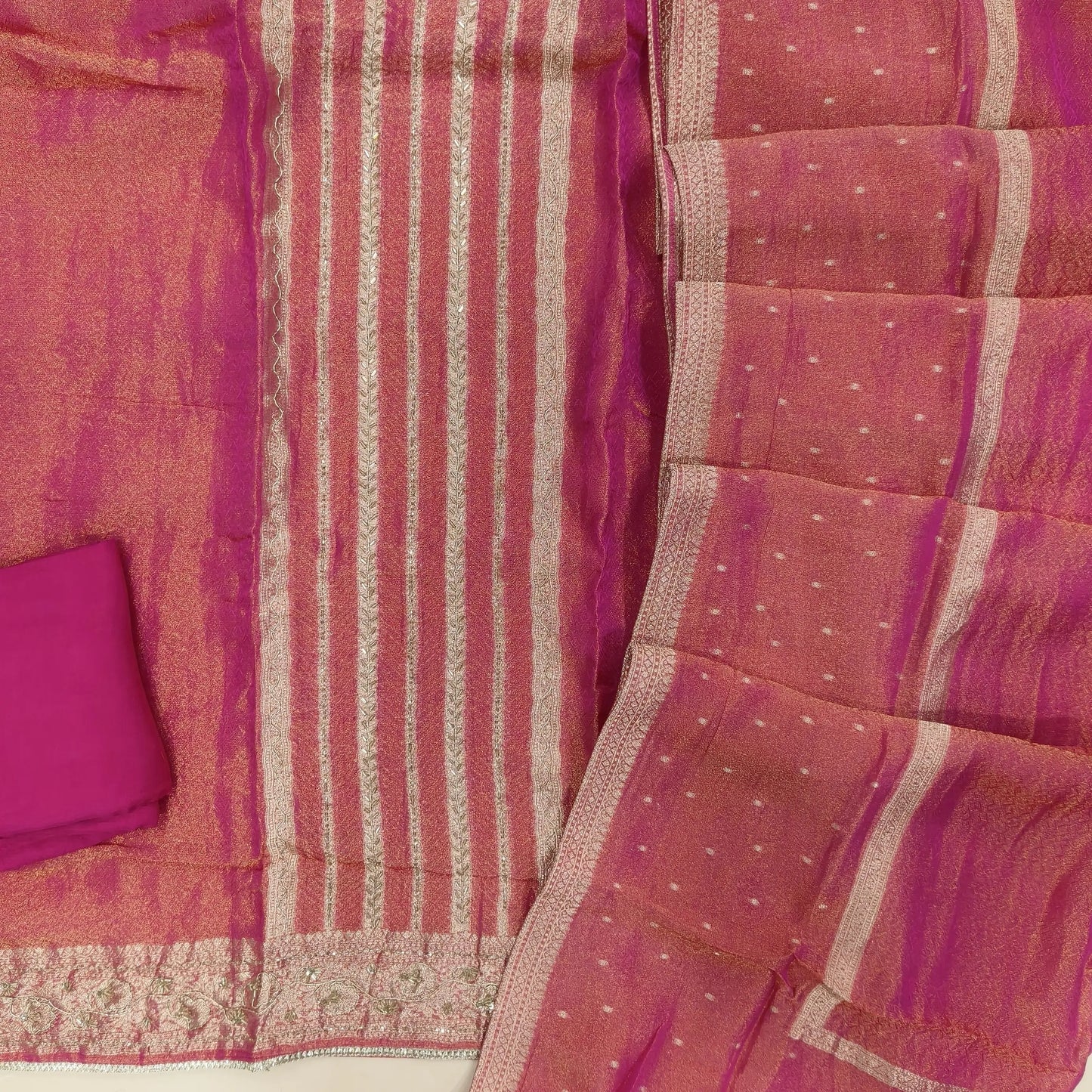 Bright pink with golden tint jakard tissue silk cotton unstitched salwar material,self design all over,cut bead and zardozi work on front, panel design, (Lining Needed)santoon bottom, tissue silk dupatta with zari woven borders. AG260801