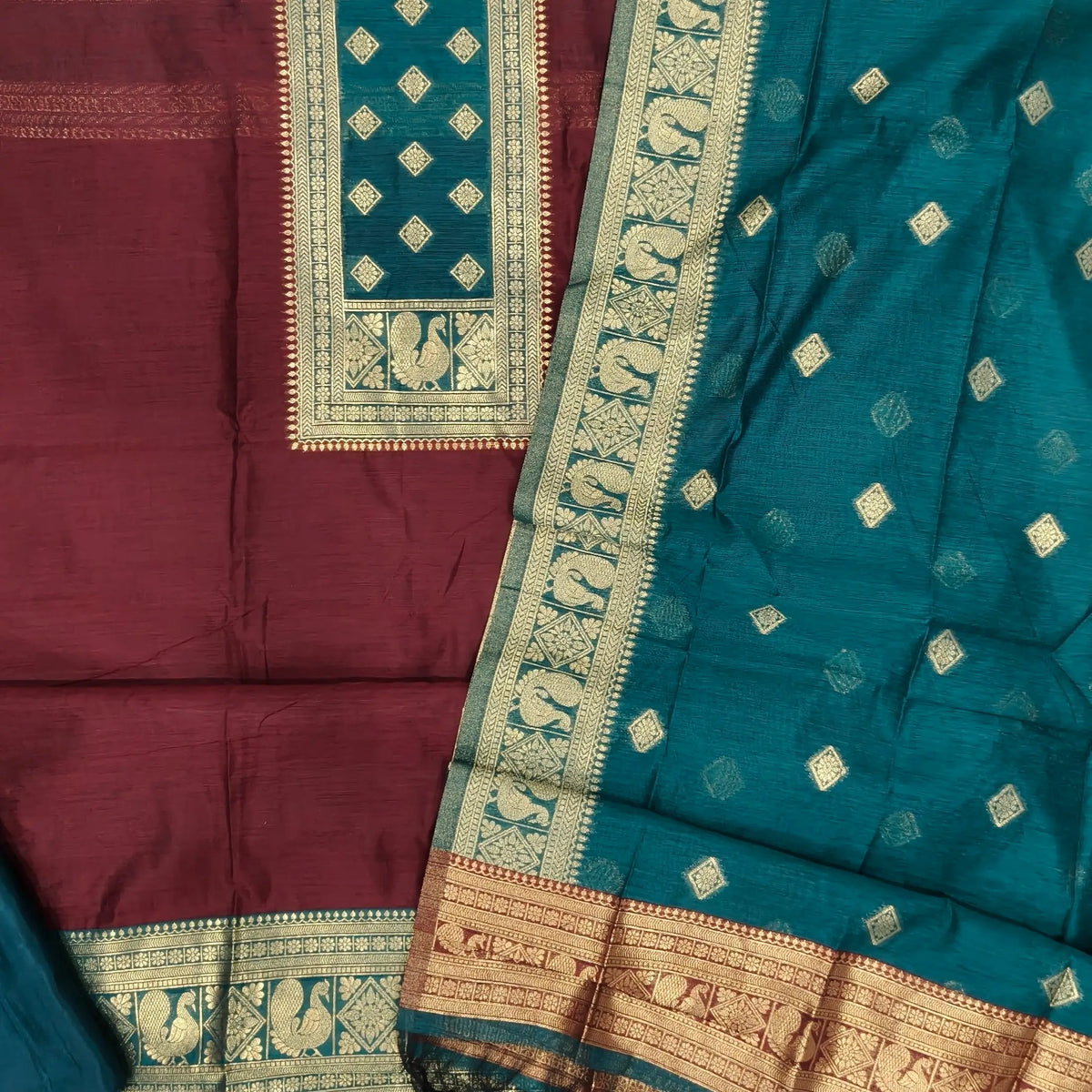 Dark maroon and teal green premium silk cotton benarasi zari woven unstitched salwar material, zari weaving on yoke&daman(Lightweight, Lining Needed)matching silk cotton bottom, zari wove silk cotton dupatta. SP261612