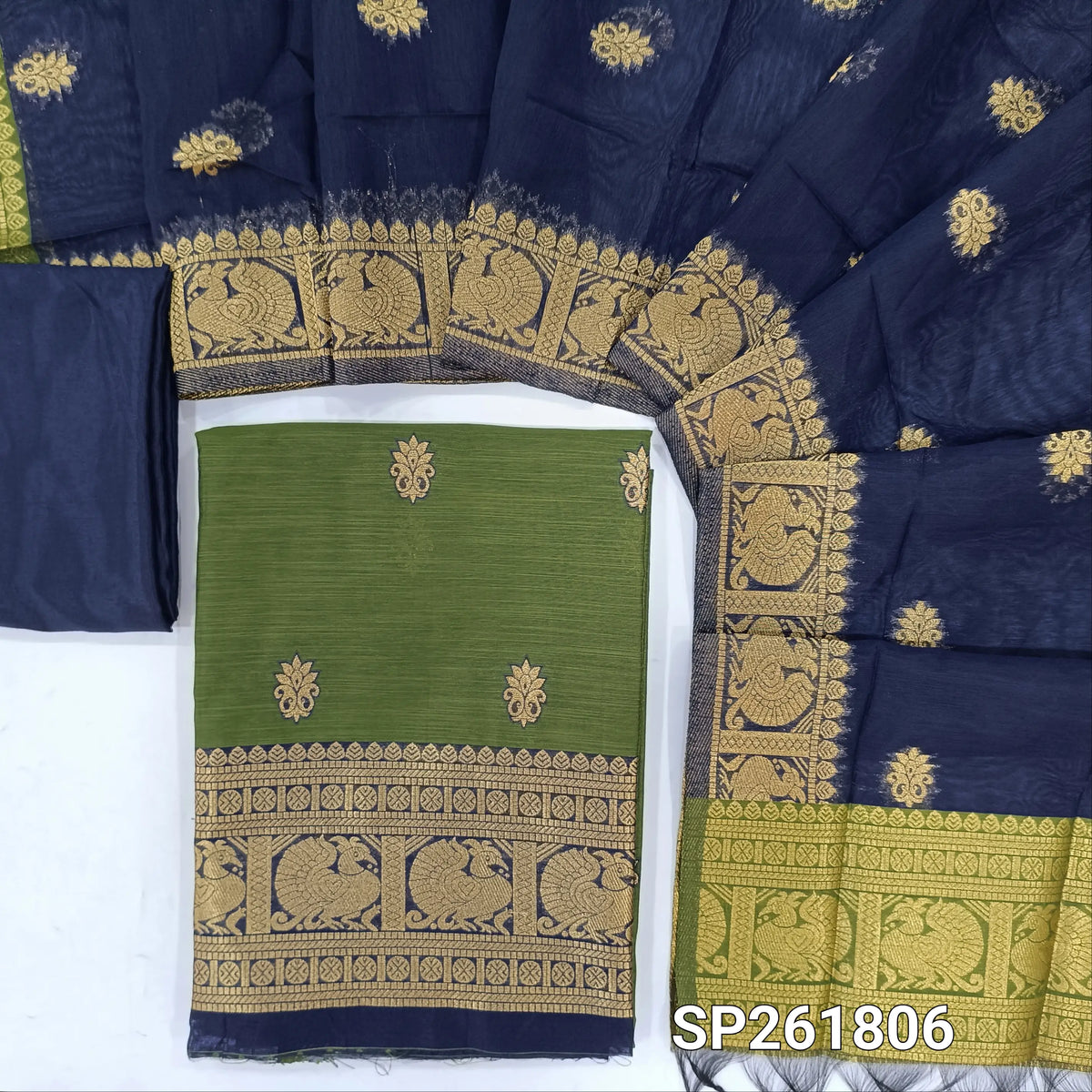 Olive green premium silk cotton unstitched salwar material,buttas all over benarasi zari weaving daman, (lining needed)dark blue silky bottom,buttas on silk cotton dupatta with pallu and borders. SP261806