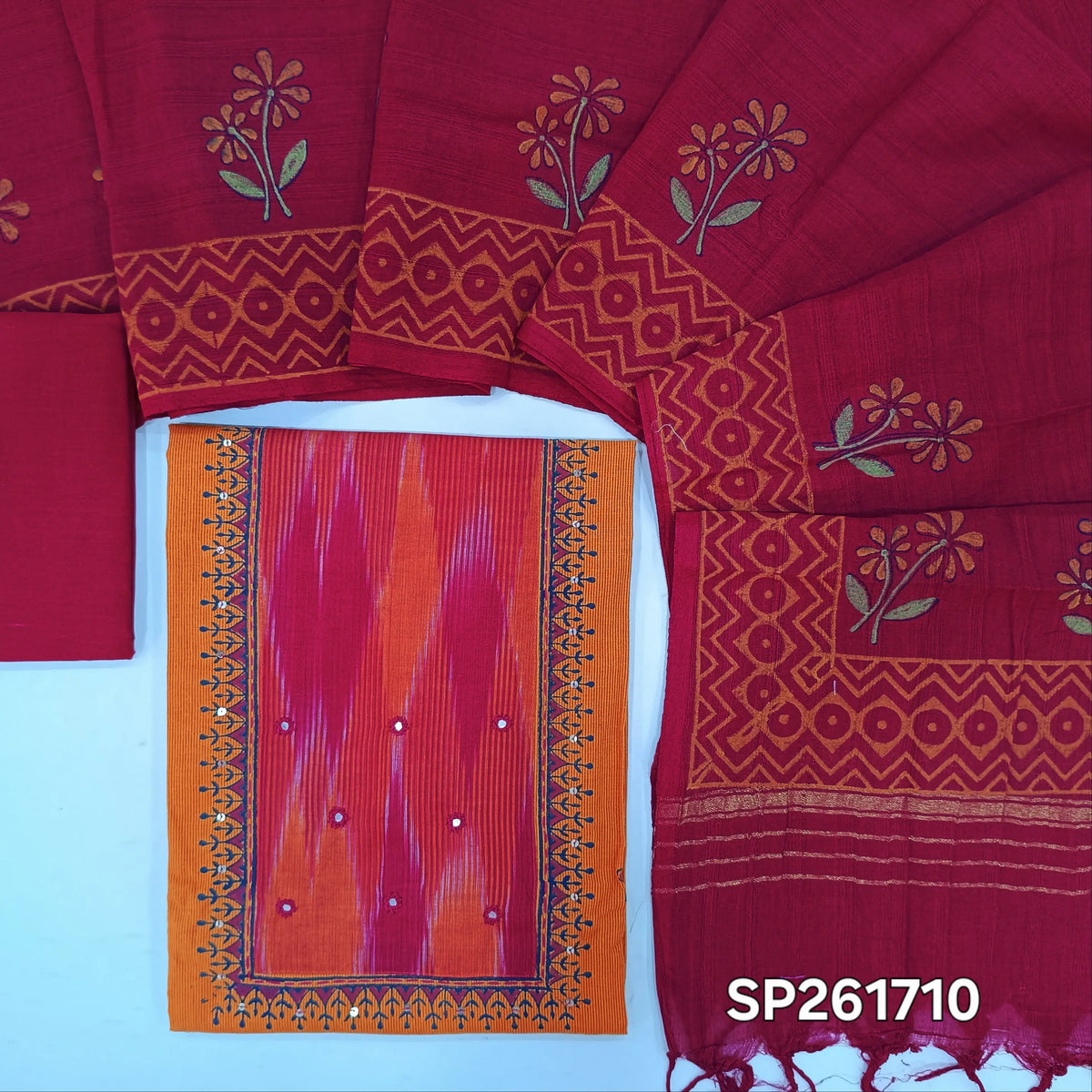 Orange with pink handloom cotton unstitched salwar material, hand block prints on front, real mirror and ikat yoke patch (Lining Optional)pure cotton bottom, mul cotton dupatta with hand block prints and zari detailing. SP261710