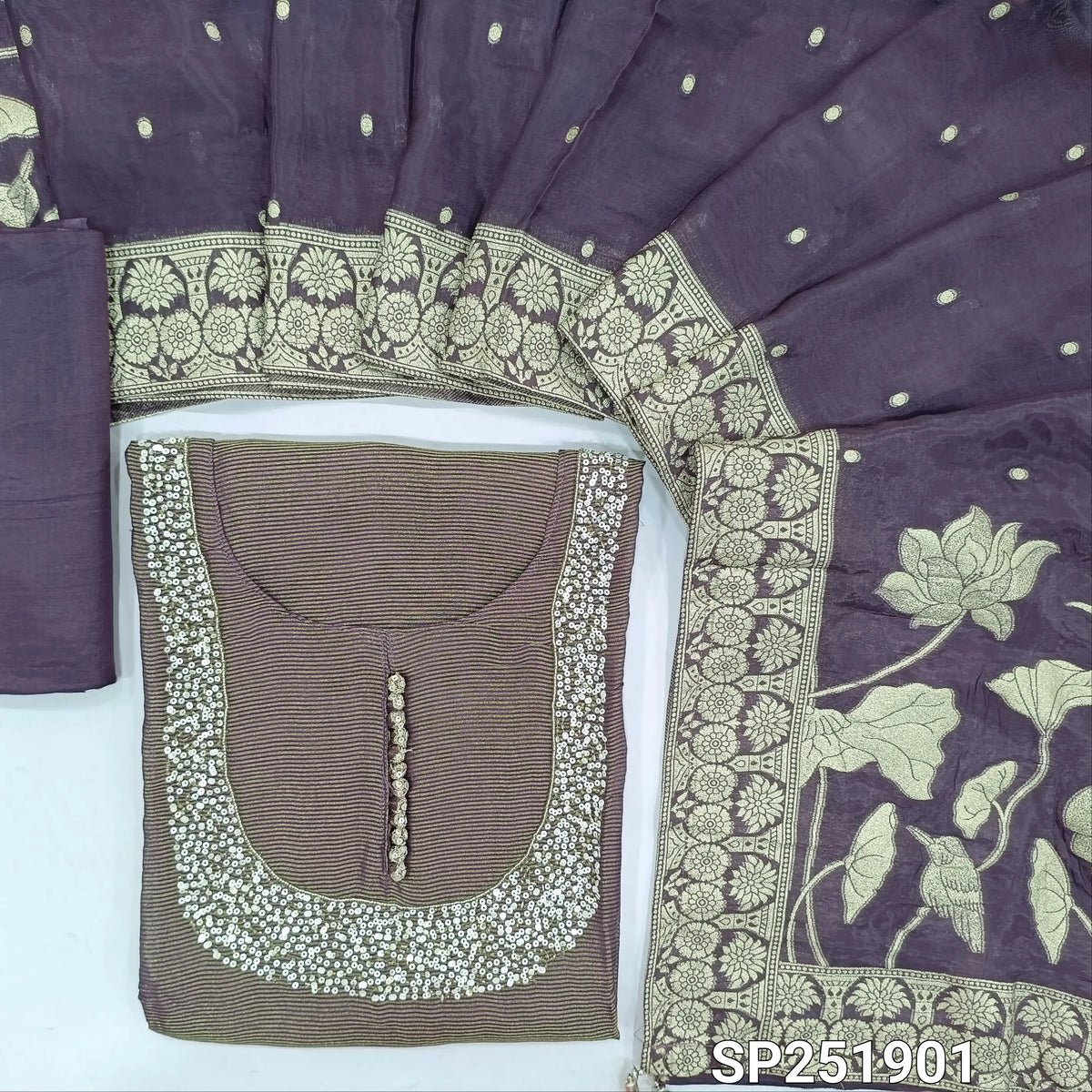 Dark purple base tissue silk cotton unstitched salwar material,cut bead, sequins and potli buttons on yoke,thin gold zari lines all over,(lining needed)santoon bottom, benarasi weaving on short width organza silk dupatta with rich pallu. SP261901