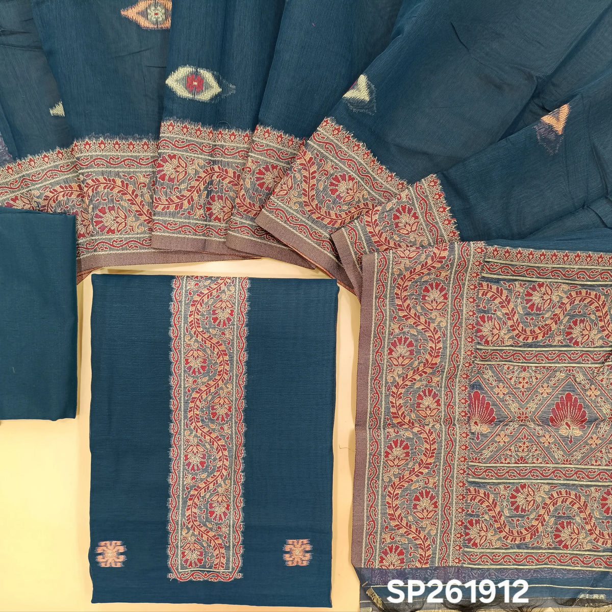 Dark blue silk cotton unstitched salwar material,buttas all over, thread weaving on yoke and daman,(lining needed)silky bottom, silk cotton dupatta with rich thread woven pallu and borders. SP261912