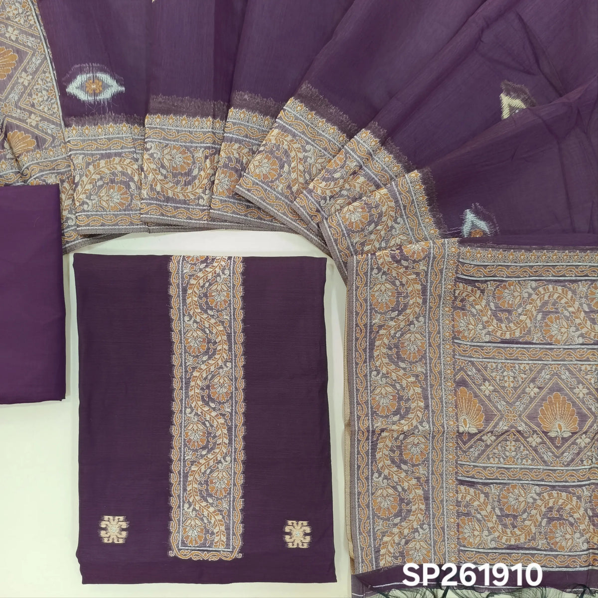 Dark purple silk cotton unstitched salwar material,buttas all over, thread weaving on yoke and daman,(lining needed)silky bottom, silk cotton dupatta with rich thread woven pallu and borders. SP261910
