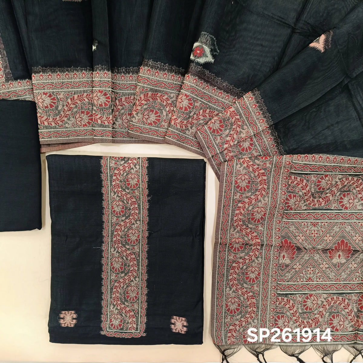 Black silk cotton unstitched salwar material,buttas all over, thread weaving on yoke and daman,(lining needed)silky bottom, silk cotton dupatta with rich thread woven pallu and borders. SP261914