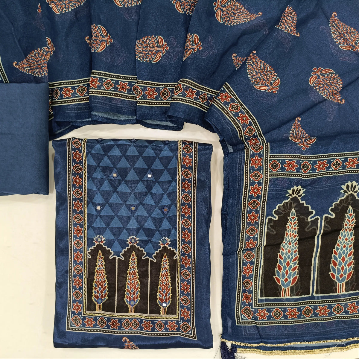 Indigo blue crepe silk unstitched salwar material, printed yoke with real mirror work, printed daman,(soft, shiny, lining needed)santoon bottom, printed short width chinon silk dupatta. SP261916