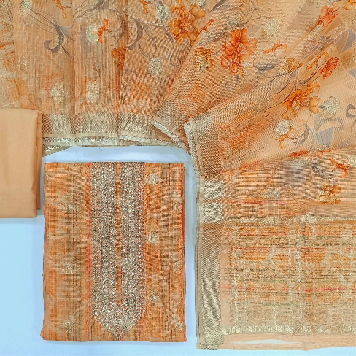 Pastel peach designer floral printed premium kota fabric unstitched salwar material, zari &sequins work on yoke, zari woven buttas all over(lining needed)matchings silk cotton bottom, floral printed kota dupatta with zari woven borders. CODE AG240803