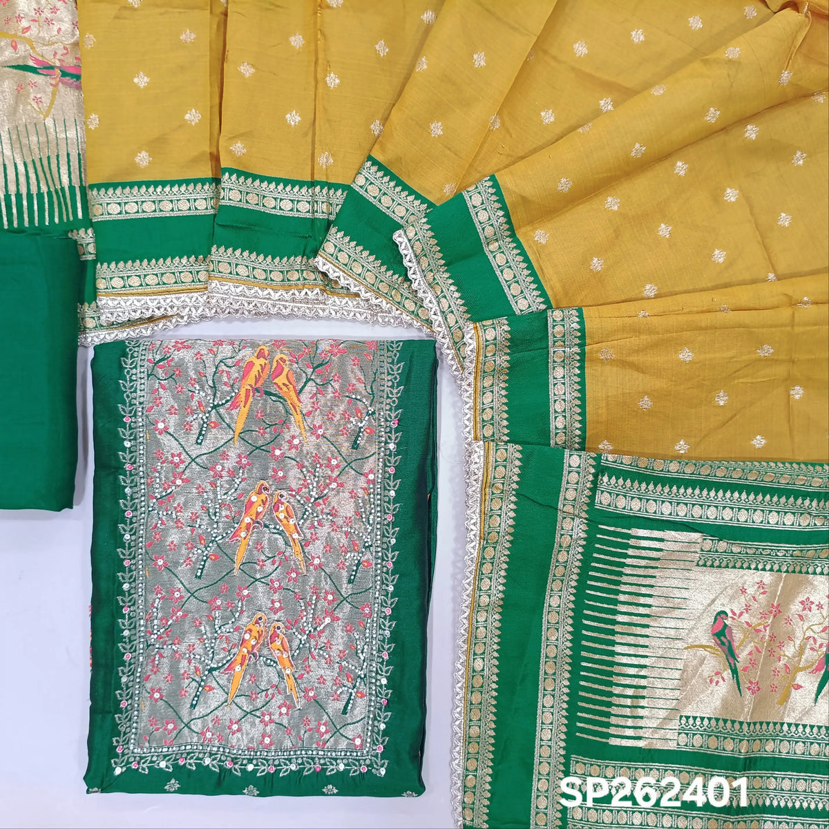 Bottle green silk cotton unstitched salwar material,rich weaving with pearl bead and sequins work on yoke,buttas on front,rich daman,(Lining Needed)spun cotton bottom, buttas on silk cotton dupatta with contrast borders & rich pallu. SP262401