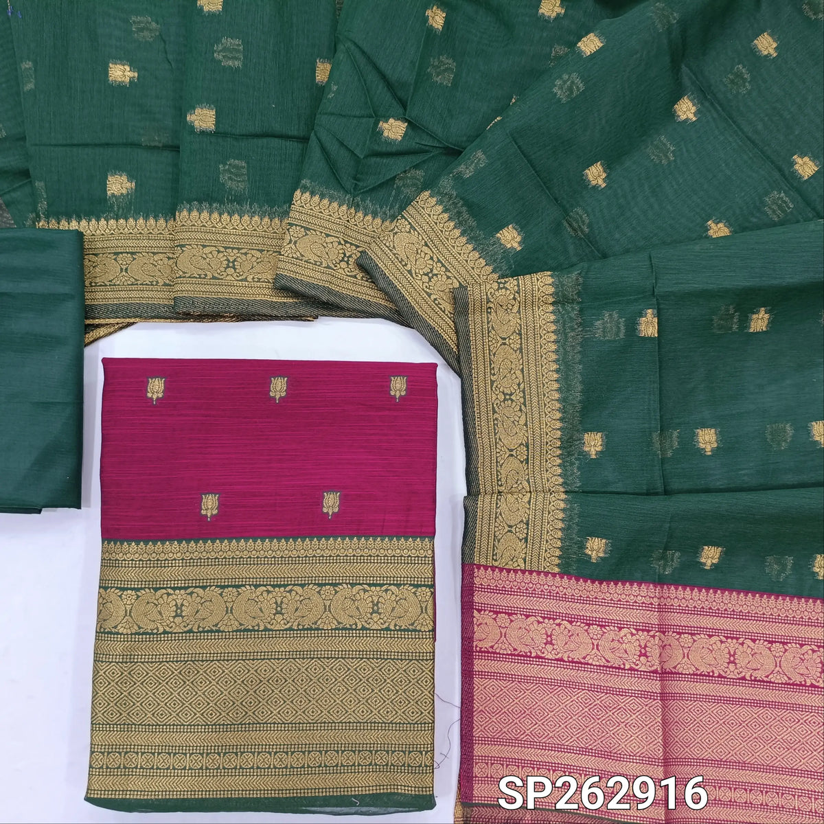 Rani pink premium silk cotton unstitched salwar material,buttas all over benarasi zari weaving daman, (lining needed)bottle green  silky bottom,buttas on dual shaded silk cotton dupatta with rich pallu and borders. SP262916