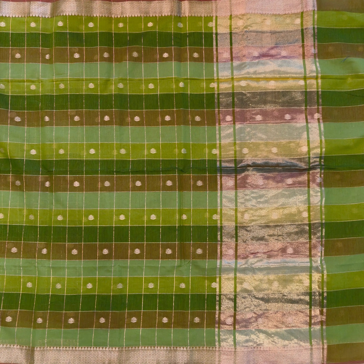 Multicoloured (Light & dark green)soft silk cotton saree with zari woven checks & buttas all over, zari woven double side borders, tissue pallu,multicoloured running blouse with borders & buttas. NS30