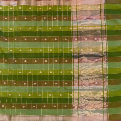 Multicoloured (Light & dark green)soft silk cotton saree with zari woven checks & buttas all over, zari woven double side borders, tissue pallu,multicoloured running blouse with borders & buttas. NS30