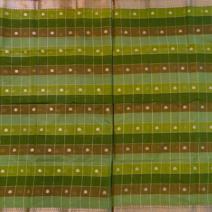 Multicoloured (Light & dark green)soft silk cotton saree with zari woven checks & buttas all over, zari woven double side borders, tissue pallu,multicoloured running blouse with borders & buttas. NS30