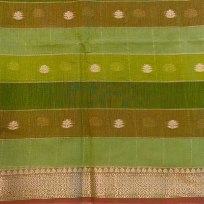 Multicoloured (Light & dark green)soft silk cotton saree with zari woven checks & buttas all over, zari woven double side borders, tissue pallu,multicoloured running blouse with borders & buttas. NS30