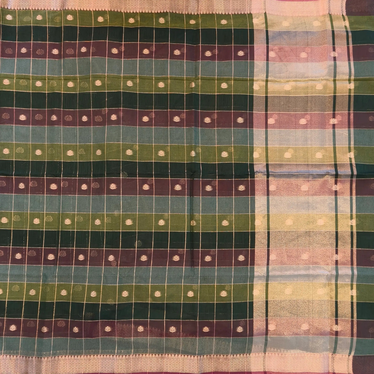 Multicoloured (Dark green & brown)soft silk cotton saree with zari woven checks & buttas all over, zari woven double side borders, tissue pallu,multicoloured running blouse with borders & buttas. NS27