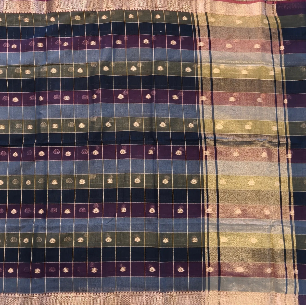 Multicoloured (Blue,purple & green)soft silk cotton saree with zari woven checks & buttas all over, zari woven double side borders, tissue pallu,multicoloured running blouse with borders & buttas. NS29
