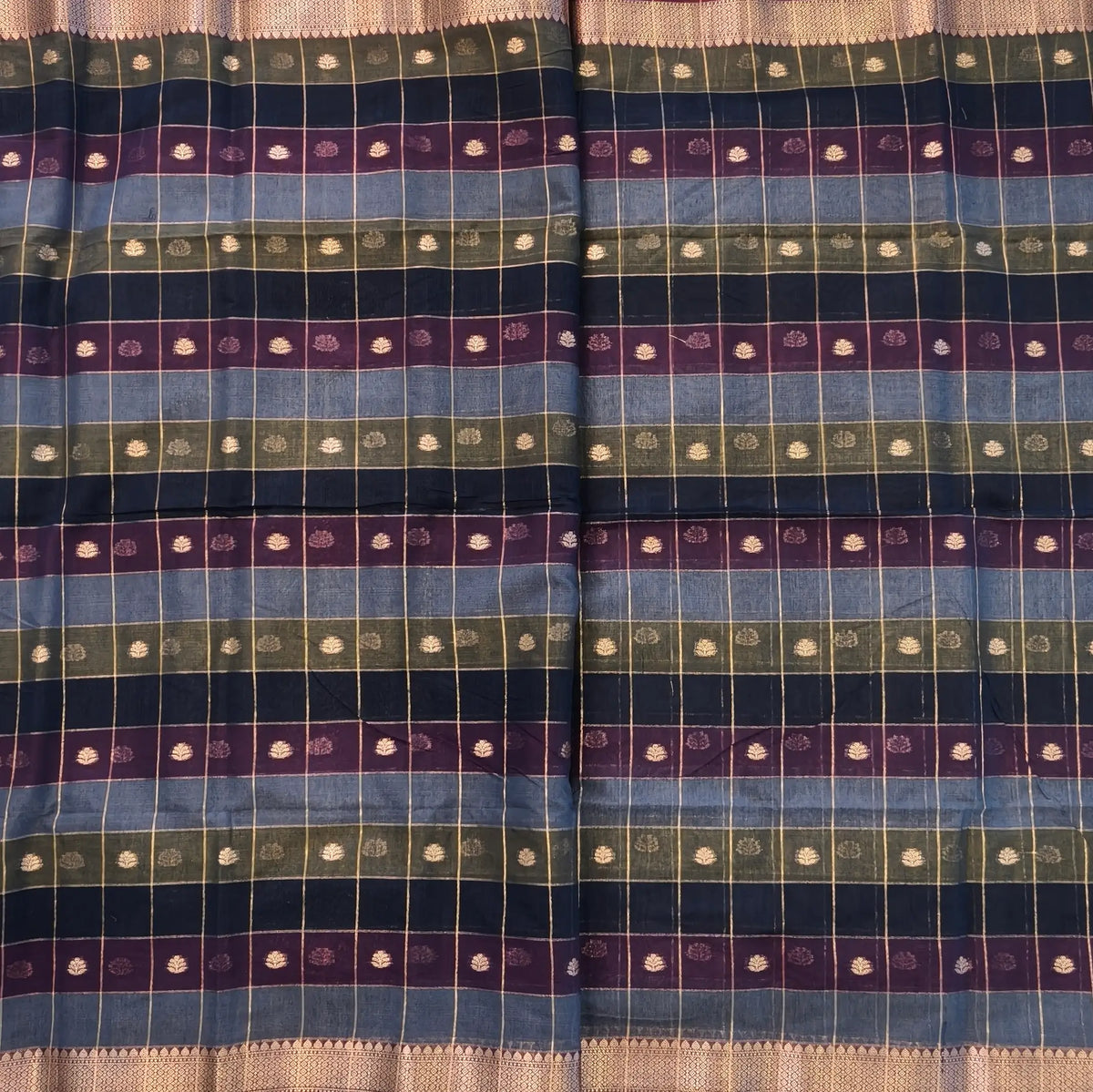 Multicoloured (Blue,purple & green)soft silk cotton saree with zari woven checks & buttas all over, zari woven double side borders, tissue pallu,multicoloured running blouse with borders & buttas. NS29