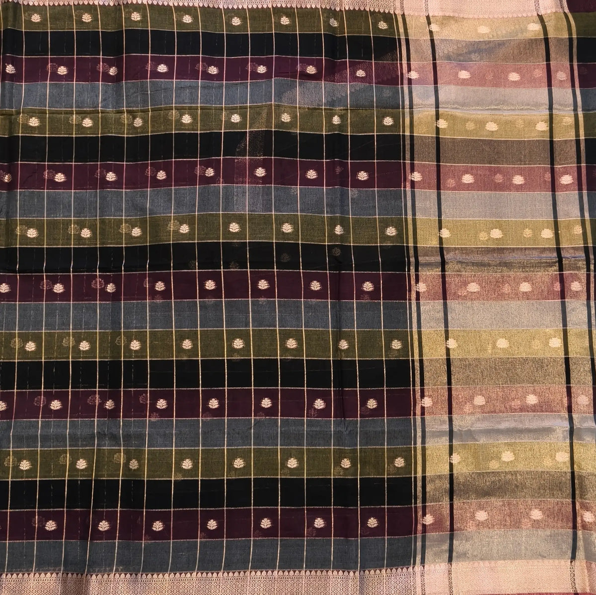 Multicoloured (Black, purple & grey)soft silk cotton saree with zari woven checks & buttas all over, zari woven double side borders, tissue pallu,multicoloured running blouse with borders & buttas. NS31