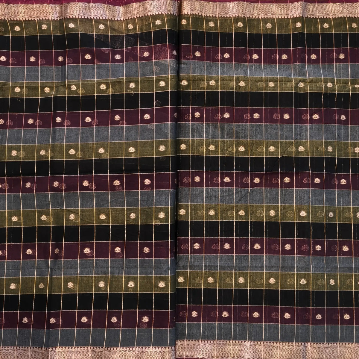 Multicoloured (Black, purple & grey)soft silk cotton saree with zari woven checks & buttas all over, zari woven double side borders, tissue pallu,multicoloured running blouse with borders & buttas. NS31