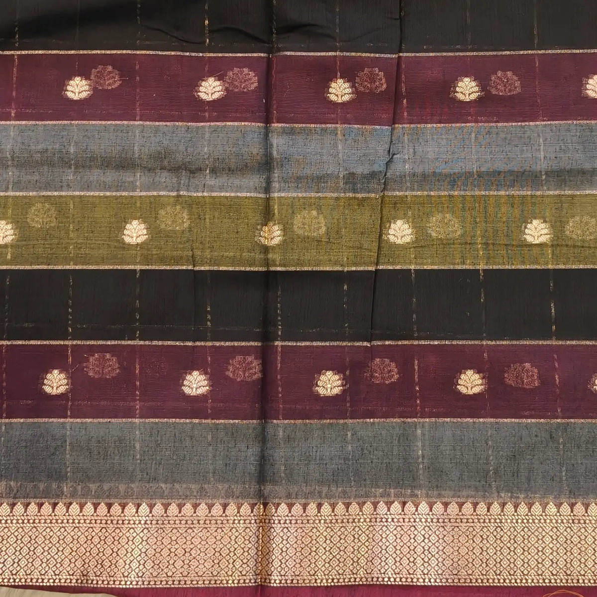 Multicoloured (Black, purple & grey)soft silk cotton saree with zari woven checks & buttas all over, zari woven double side borders, tissue pallu,multicoloured running blouse with borders & buttas. NS31