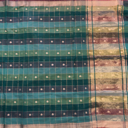 Multicoloured (Turquoise blue & green)soft silk cotton saree with zari woven checks & buttas all over, zari woven double side borders, tissue pallu,multicoloured running blouse with borders & buttas. NS24